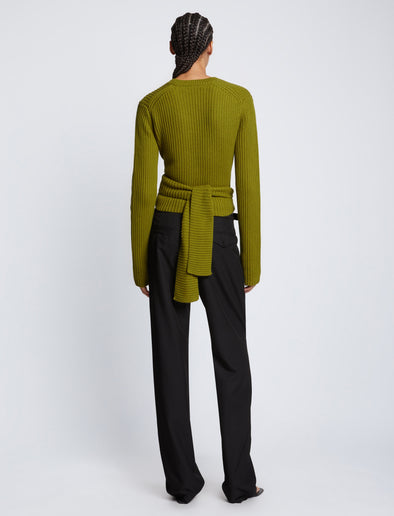 Back full length image of model wearing Ribbed Cotton Wrap Sweater in LEAF