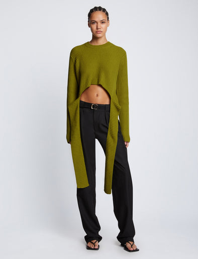 Front full length image of model wearing Ribbed Cotton Wrap Sweater in LEAF with straps hanging by sides