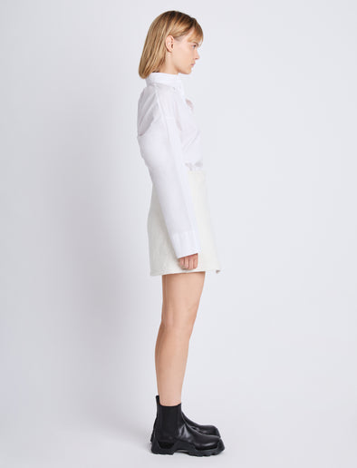 Side full length image of model wearing Tweed Wrap Skirt in OFF WHITE