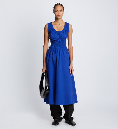 Front full length image of model wearing Poplin Gathered Dress in ROYAL BLUE styled over black Viscose Suiting Pants