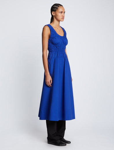 Side full length image of model wearing Poplin Gathered Dress in ROYAL BLUE