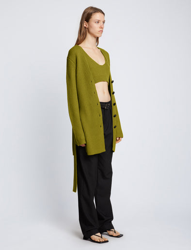 Side full length image of model wearing Ribbed Cotton Relaxed Cardigan in LEAF