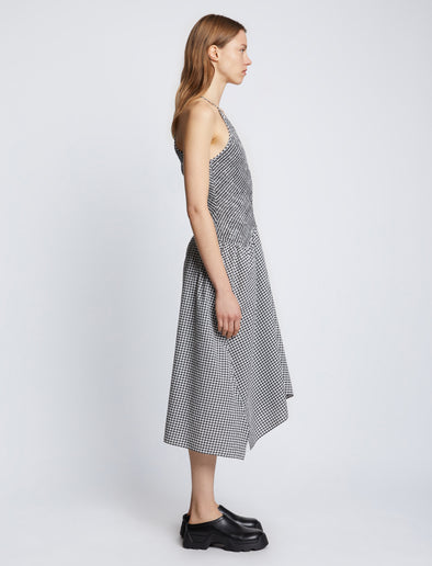 Side full length image of model wearing Gingham Seersucker Smocked Dress in OFF WHITE/BLACK