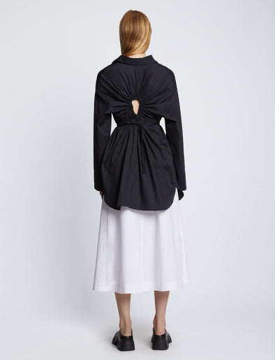 Back full length image of model wearing Soft Poplin Button Down Shirt Dress in BLACK