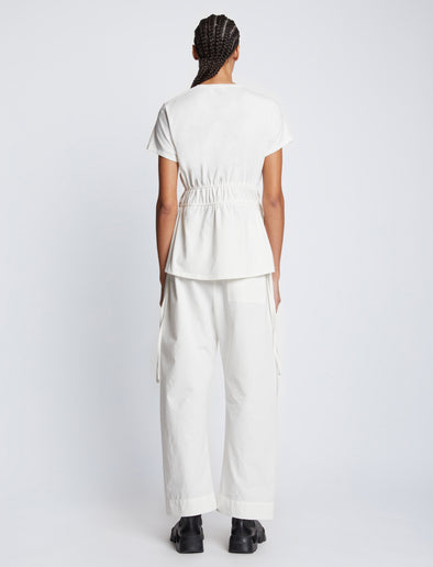 Back full length image of model wearing Ruched Side Tie T-Shirt in OFF WHITE