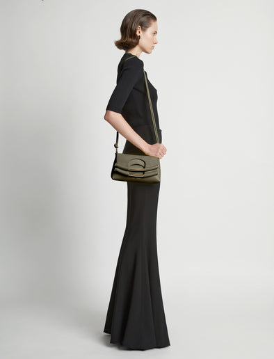 Image of model carrying Small Bar Bag in OLIVE on shoulder