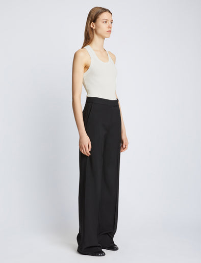 Side full length image of model wearing Matte Viscose Rib Knit Tank in WHITE