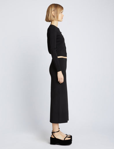 Side full length image of model wearing Silk Viscose Knit Skirt in BLACK