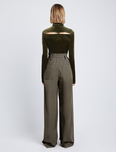Back full length image of model wearing Stretch Velvet Turtleneck Top in MILITARY buttoned