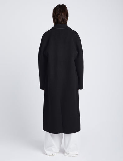 Back full length image of model wearing Reversible Double Face Coat in BLACK / STEEL GREY on BLACK side