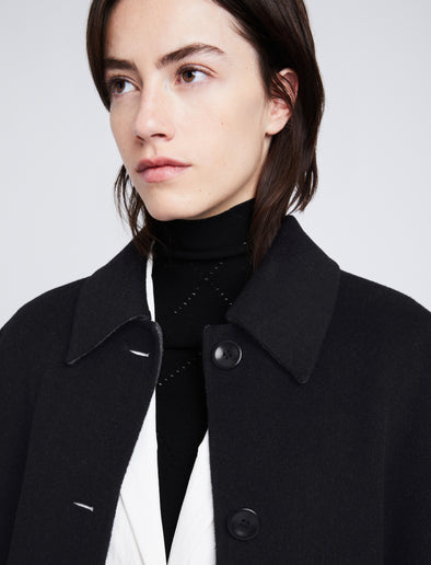 Detail image of model wearing Reversible Double Face Coat in BLACK / STEEL GREY on BLACK side