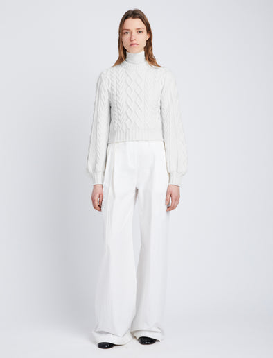 Front full length image of model wearing Chunky Cable Bell Sleeve Sweater in OFF WHITE
