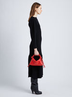 Image of model wearing Mini Drawstring Bag in NEW SCARLET