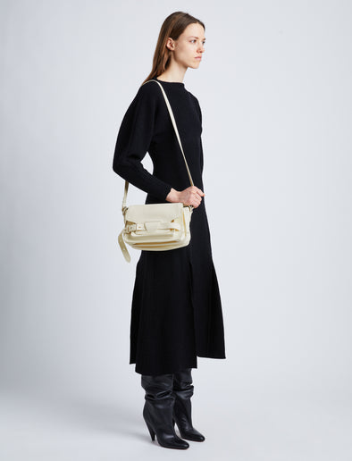 Image of model wearing Beacon Saddle Bag in ECRU