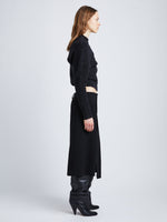 Side full length image of model wearing Wool Twill Skirt in BLACK