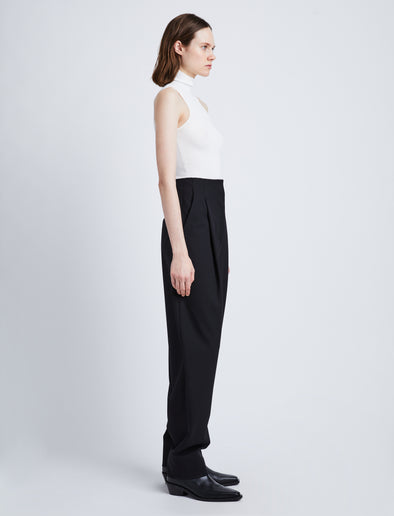 Side full length image of model wearing Matte Viscose Knit Top in WHITE