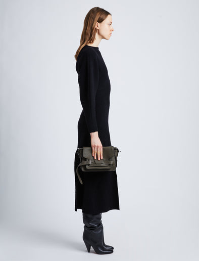 Image of model wearing Beacon Saddle Bag in OLIVE