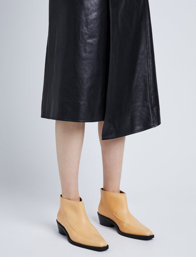 Image of model wearing BRONCO ANKLE BOOTS in NATURAL