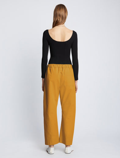 Back full length image of model wearing Solid Cotton Linen Easy Pants in GOLD