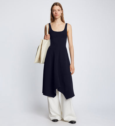 Front full length image of model wearing Barre Bustier Dress in NAVY styled over white Drapey Suiting Pants