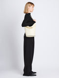 Image of model wearing Leather Spring Bucket Bag in IVORY
