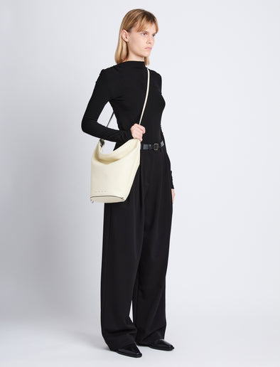 Image of model wearing Leather Spring Bucket Bag in IVORY