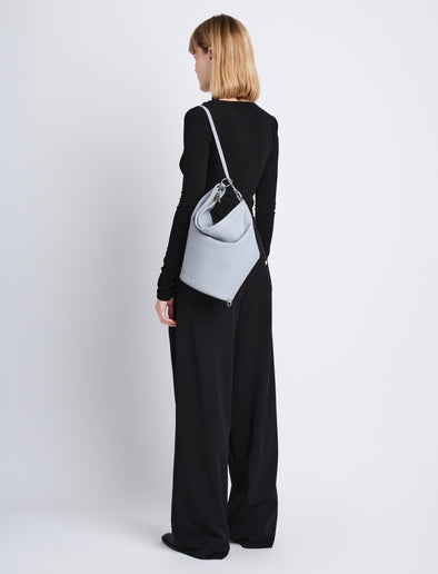 Image of model wearing Spring Bag In Leather in ash as sling