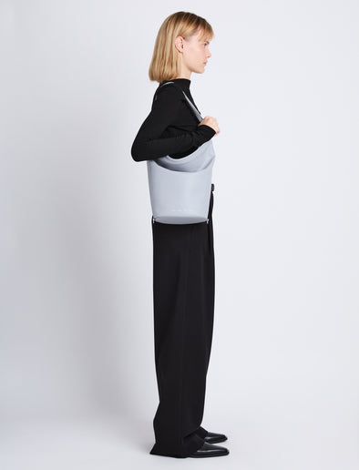 Image of model wearing Spring Bag In Leather in ash on shoulder