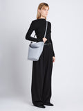 Image of model wearing Spring Bag In Leather in ash crossbody