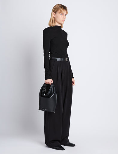 Image of model wearing image of Spring Bag In Leather in black in hand