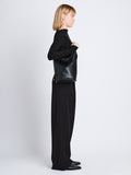 Image of model wearing  image of Spring Bag In Leather in black on shoulder