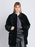 Cropped front image of model in Penelope Coat In Faux Mink in pine