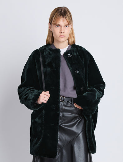 Cropped front image of model in Penelope Coat In Faux Mink in pine