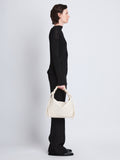 Image of model wearing Medium Drawstring Shoulder Bag in IVORY