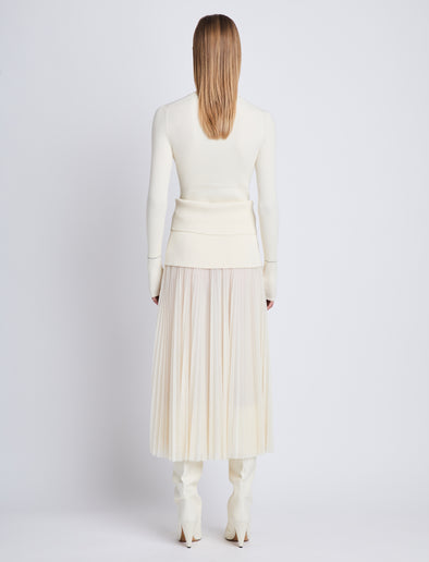 Back full length image of model wearing Agnes Henley Sweater in IVORY