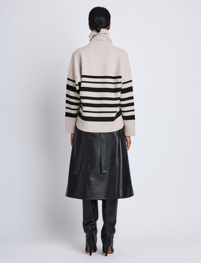Back full length image of model wearing Sandra Turtleneck In Striped Doubleface Cashmere in OATMEAL MULTI
