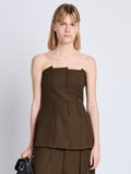 Front cropped image of model wearing Corinne Strapless Top in DARK LODEN