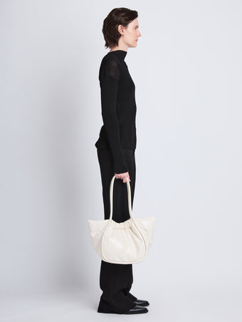 Image of model wearing Large Puffy Nappa Ruched Tote in IVORY