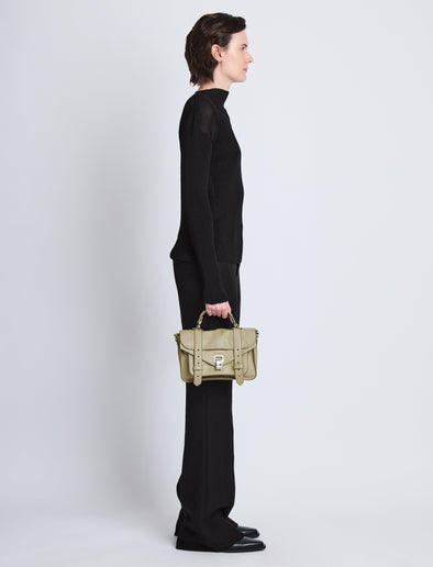 Proenza Schouler Image of model wearing PS1 Tiny Bag in cement