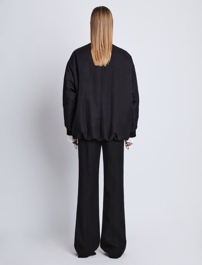 Back full length image of model wearing Ray Bomber In Recycled Nylon Twill in BLACK