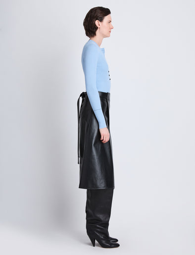 Side full length image of model wearing Agnes Henley Sweater in LIGHT BLUE