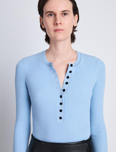Detail image of model wearing Agnes Henley Sweater in LIGHT BLUE