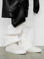 Image of model wearing Vans x Proenza Schouler Puffy Slip-On Shoes in ecru
