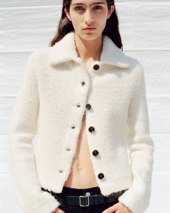 4x5 crop of model Sara Caballero wearing the Sylvie Jacket in Ivory for PS25 Lookbook against a white tarp