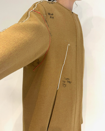 4x5 iPhone image of the Albers coat in fittings with tape and markings