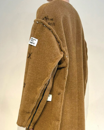 4x5 iPhone image of the Albers coat in fittings with tape, pins, and markings