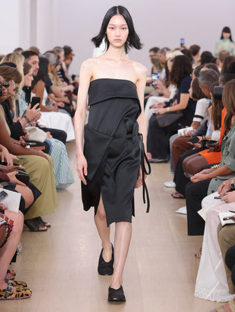 Runway image of model wearing Cecile Strapless Dress In Matte Satin in black
