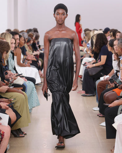 Runway image of model in Margot Dress In Glossy Leather in black