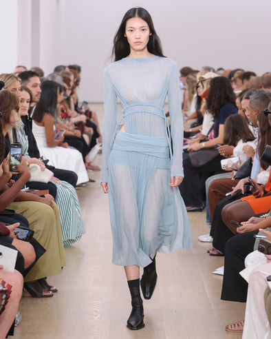 Runway image of model wearing Riley Dress In Pleated Jersey in steel