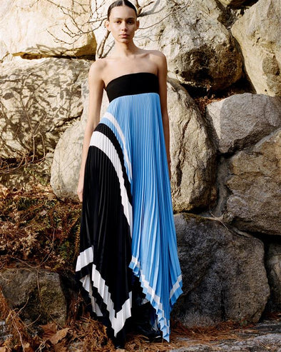 Proenza Schouler Front full length image of model standing against a rock wall wearing Fia Dress In Technical Crepe in Sky Blue Multi